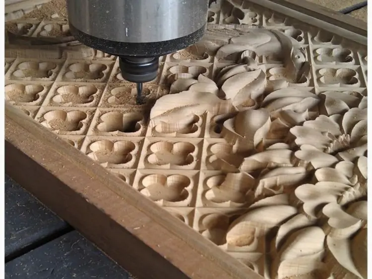 CNC wood router machine carving intricate 3D patterns on timber