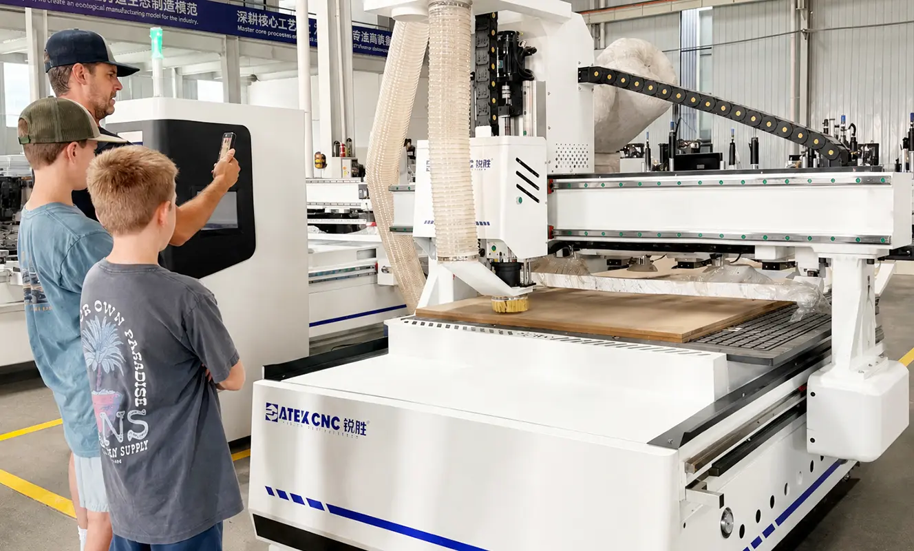 American customers are watching a CNC nesting machine process cabinet panels