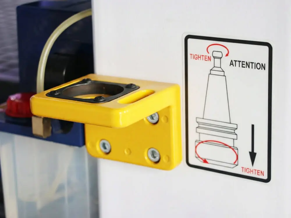 Tool collet disassembly station for ATC CNC nesting machine