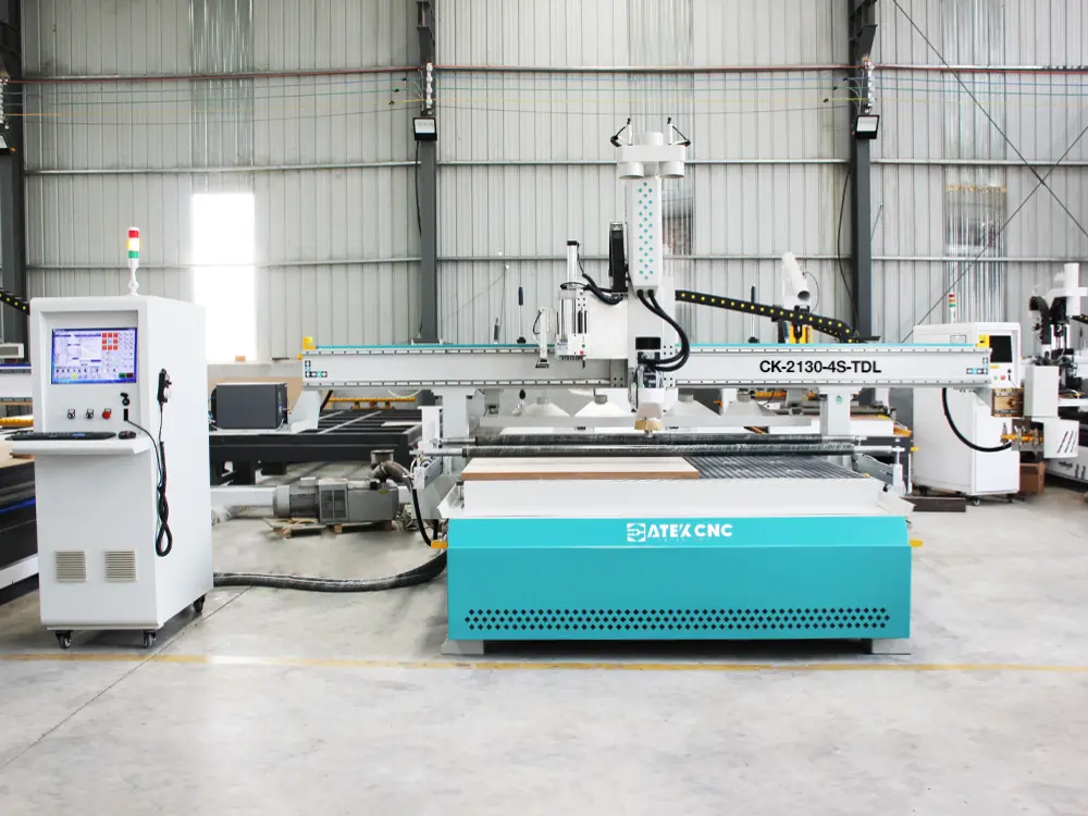 Front view of the 4-axis swivel head ATC CNC router with auto-labeling device and drilling bank Front view of the 4-axis swivel head ATC CNC router with auto-labeling device and drilling bank