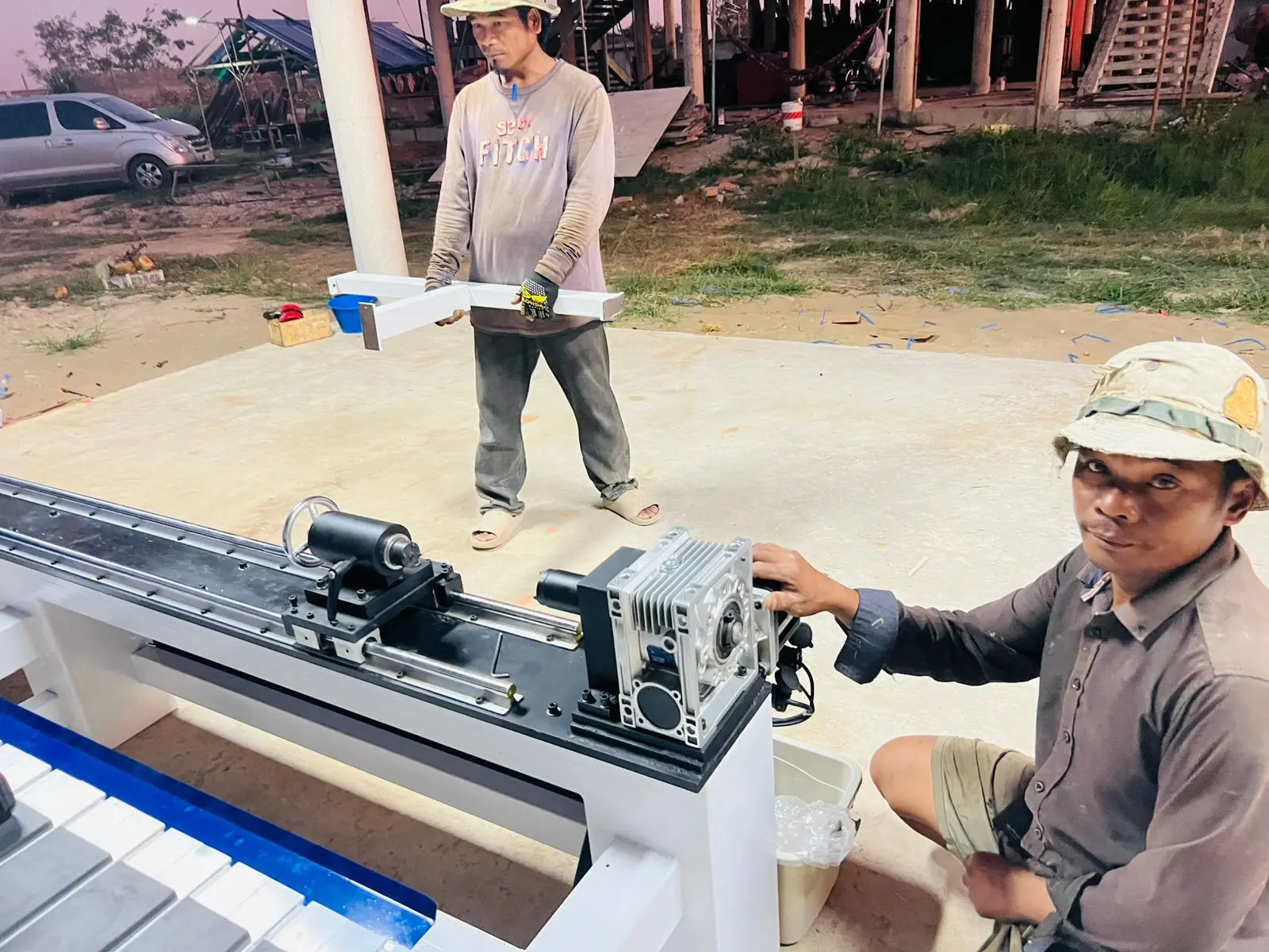The Cambodian customer is assembling and testing a CNC wood router machine with a 4th-rotary axis.