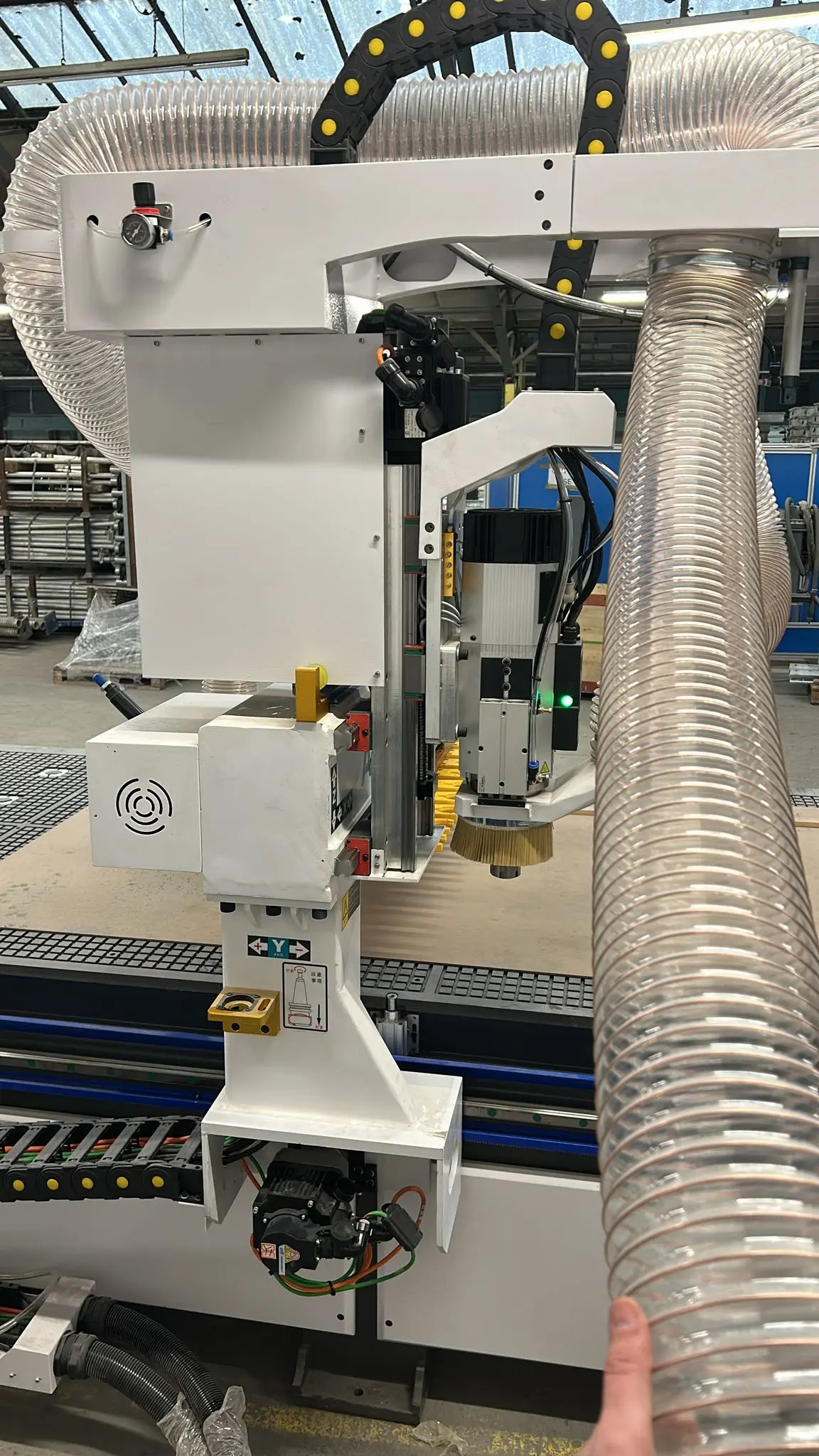 The UK customer is installing and commissioning a Model 1540-T ATC CNC woodw router machine